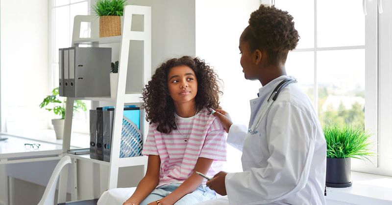 Female pediatrician talking to patient