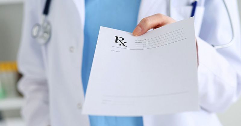 Doctor holding prescription for medication