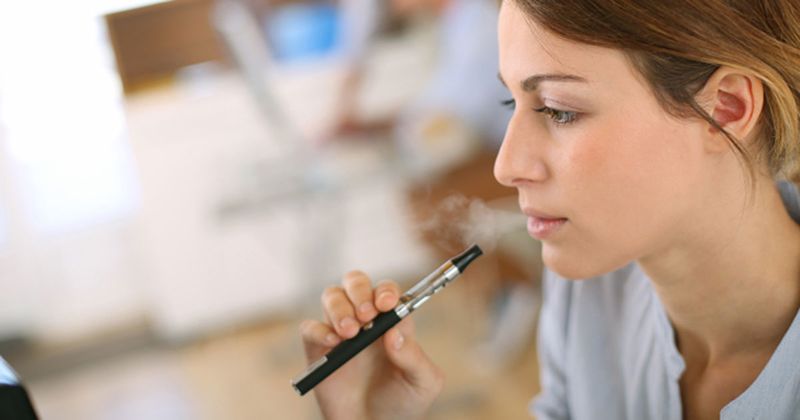 Woman vaping from an e-cigarette