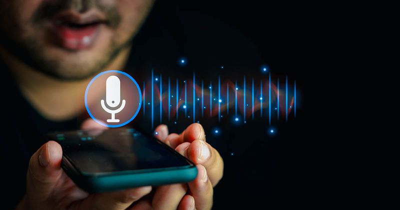 Close up of man recording his voice with a smart phone.