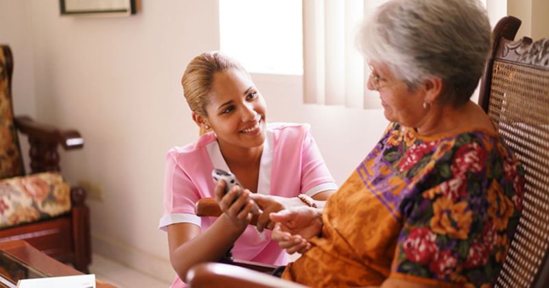 Photo of woman at home with nurse