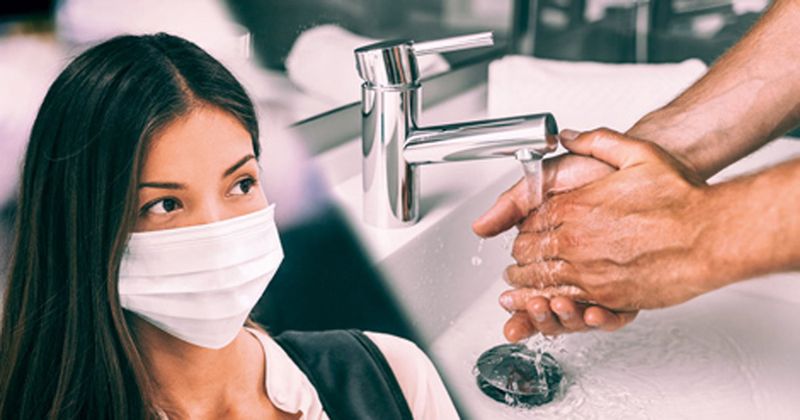 woman wearing face mask, pair of hands being washed