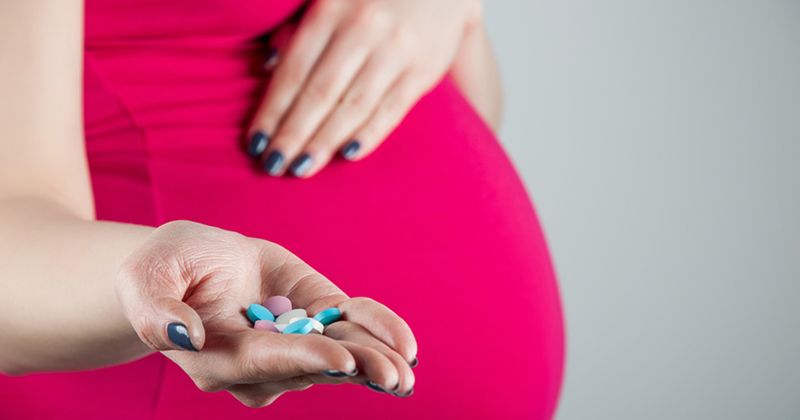 pregnant woman with pills