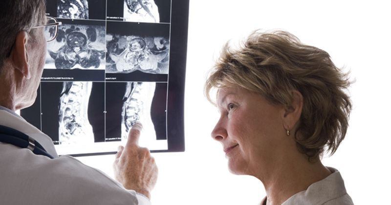 Doctor with patient showing spine MRI