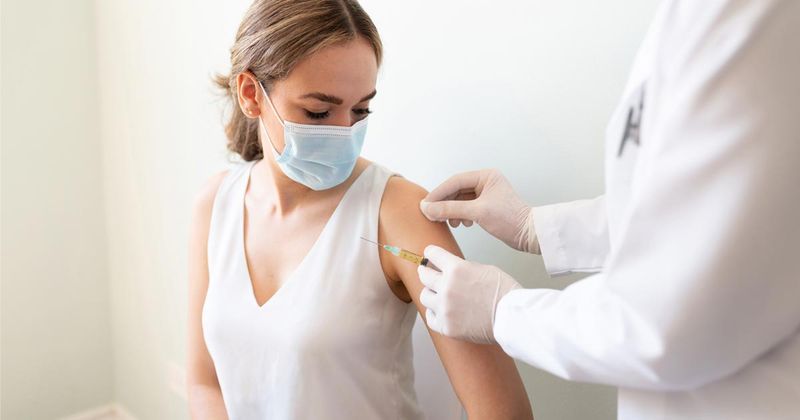 A woman gets vaccinated. 