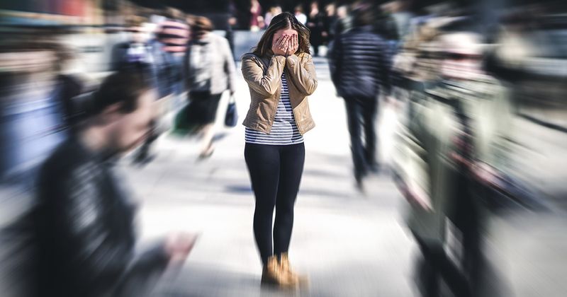 Woman in focus, others blurred