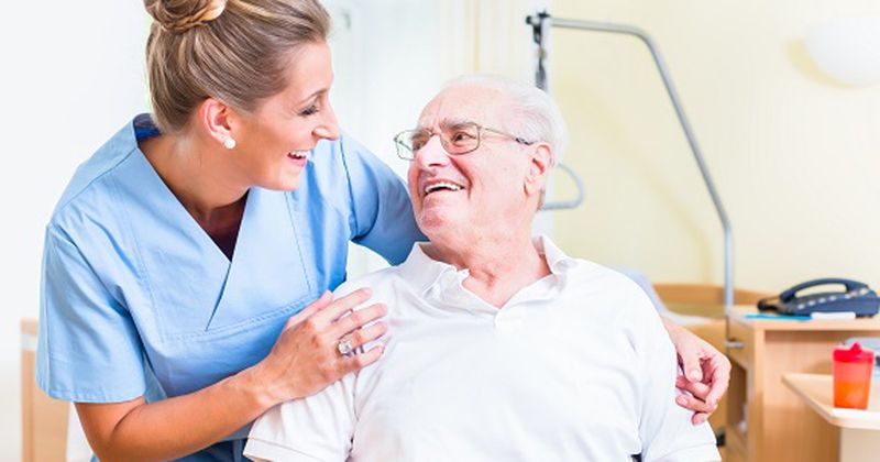 younger woman and older man talking pleasantly