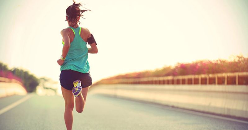 woman running along road