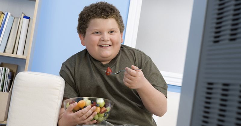 Kid eating and smiling