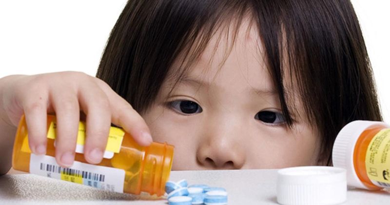 Child and pills on a table