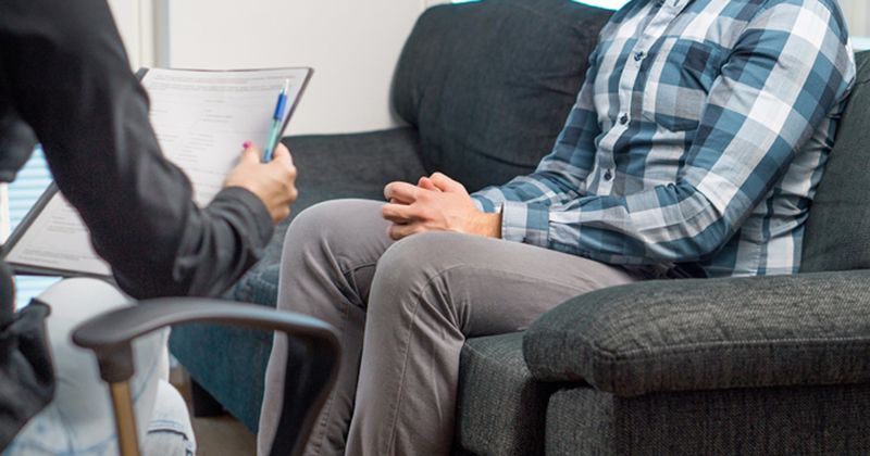 man on couch at psychiatrist's office